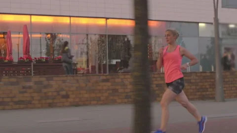 Young active athlete jogging in the city in the morning. Video stock 132767582