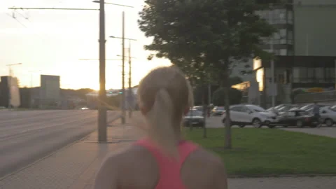 Young active athlete jogging in the sunny city in the morning. Stock Footage 132764779