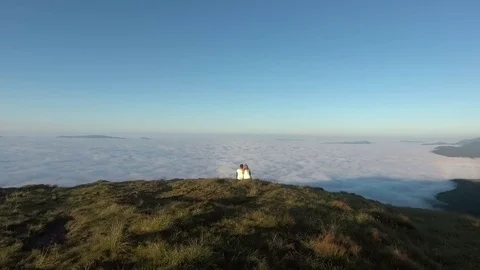 Young active couple sitting and looking at view in mountain Stock Footage 81232097