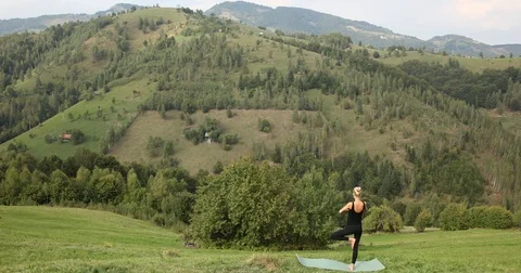 Young Active Girl Relaxes by Practicing Yoga Exercises Mountain Cliff Sunny Day Stock Footage 77018654