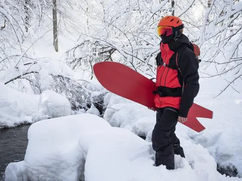 Young active guy with snowboard Фото