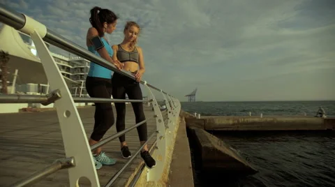 Young active ladies having interesting conversation after morning exercises near Stock Footage 68805258