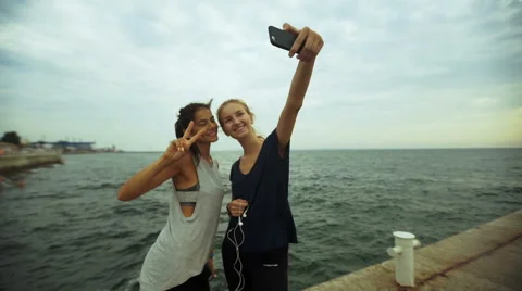 Young active ladies taking selfie after long morning jogging Stock Footage 68805776