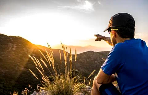 Young Active Man Pointing Direction Into The Distant Valley Stock Photos