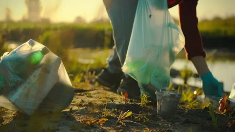 Young active man taking the initiative, collects plastic waste, sorting it i Stock Footage 275730893