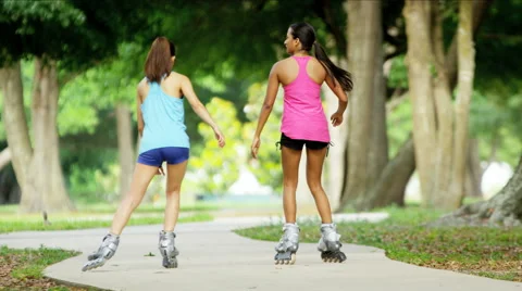 Young active multi ethnic American girls rollerblading outdoor Stock Footage 53889353