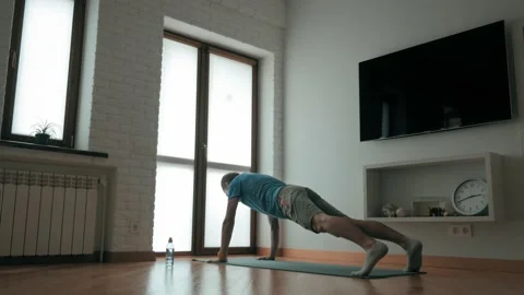 Young active sport man making push ups exercise at home during self isolation Video stock 133553161