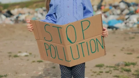 Young Activist Protests Pollution with Handwritten Cardboard Sign Stock Footage 309299749