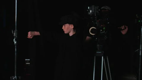 The young actor pulls back the screen and looks at the stage Stock Footage 165300252