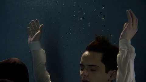 The young actor submerges under the water to perform in the art performance Video stock 88871489