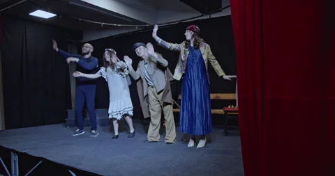 Young Actors Bowing to Applause After a Successful Theater Play Performance on Stock Footage 313064733