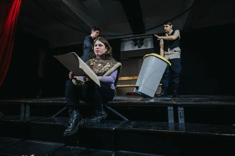 Young actors performing a dramatic scene together on stage in a theater setting Stock Photos