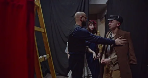 Young Actors Prepare Backstage: Director Guides and Adjusts Costumes Before Stock Footage 312072338