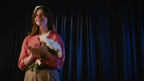 Young Actress Clapping with Flower Bouquet on Theater Stage Stock Footage 344529770