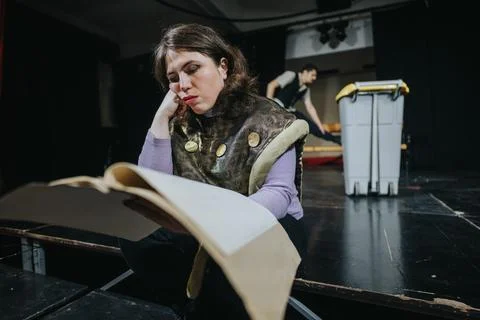 Young actress reading a script on stage during theatre rehearsal Stock Photos