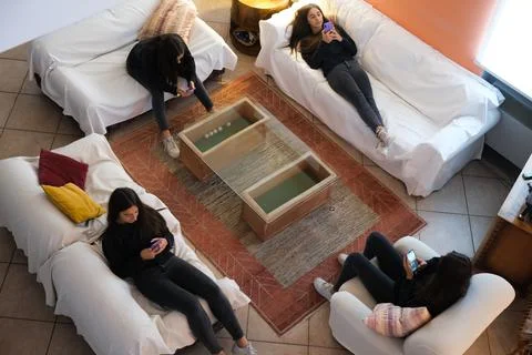 Young adolescent using mobile on sofa. Contemporary loneliness, mobile addict Stock Photos