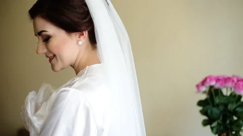 Young adorable happy bride touching her wedding dress and smile on camera Stock Footage 61639394