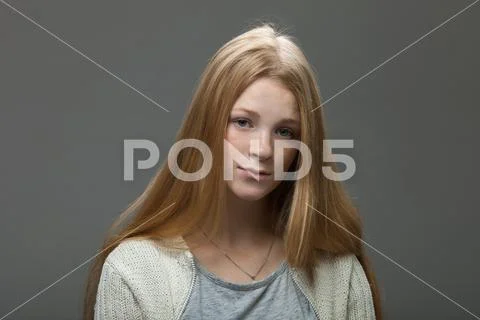 Young adorable redhead woman with pouting lips in cozy shirt looking confused. Stock Photos