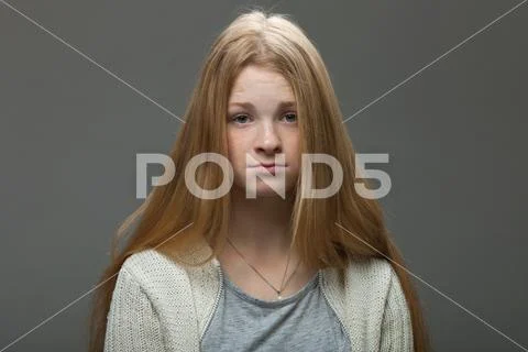 Young adorable redhead woman with pouting lips looking confused. Stock Photos