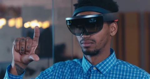 Young adult African American male using holographic augmented reality glasses Stock Footage