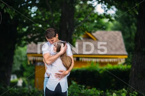 Young adult brunette man and woman in the park Stock Photos