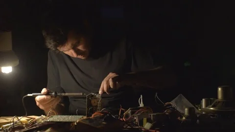 A young adult caucasian man technician working indoors Stock Footage