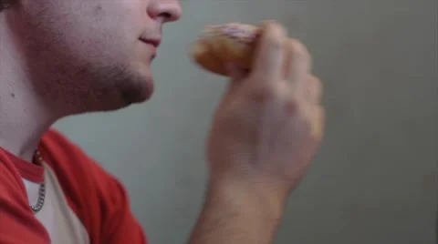 Young Adult Devours Dougnut Stock Footage 41554360