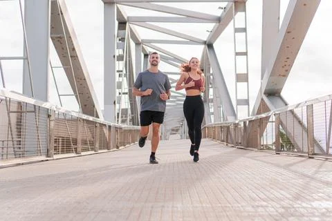 Young adult friends doing a morning marathon in the morning outdoor. Man and Stock Photos