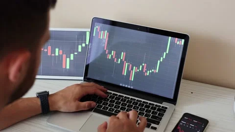 Young adult man trading on line with tablet pc connected to stock market. People Stock Footage