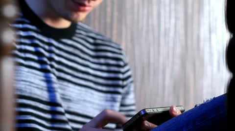Young adult man using touchscreen phone. Stock Footage 12046162