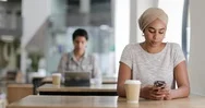 Young Adult Muslim Female Using A Smartphone In A Cafe Stock Footage