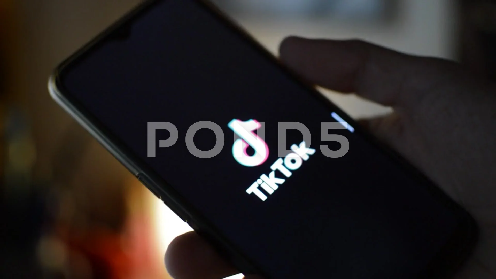 young adult with tiktok logo on the phone, tik tok social network internet  app