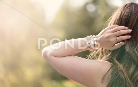 Young adult woman enjoying the bright day outdoors Stock Photos