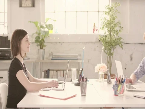 Young adults discussing around a computer desk in startup office - track right. Stock Footage 72856957