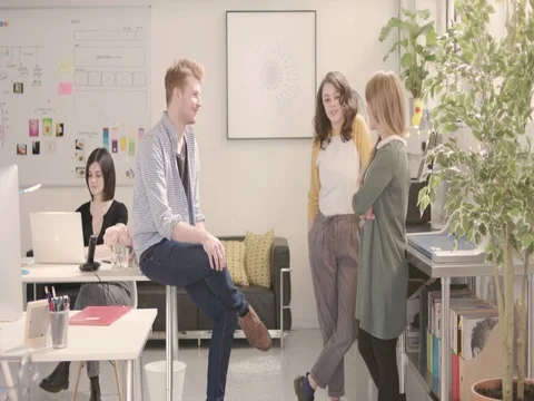 Young adults talking in startup office - slow track forwards. Stock Footage 72852623