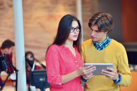 Young adults in training course using touchpad Stock Photos