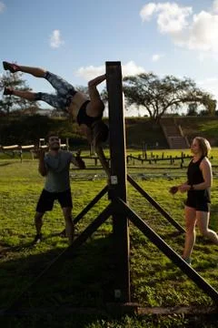Young adults training at an outdoor gym bootcamp Stock Photos