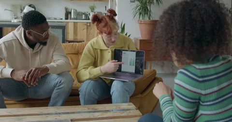 Young adults using Digital tablet for Presentation on Sofa in Warehouse Loft Stock Footage 244880036