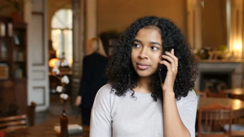 Young African American Black Woman Walking Talking On Cell Phone In Cafe Stock Footage 98584169