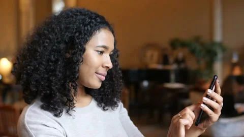 Young African American Black Woman Having Fun Using Smart Phone Technology In Stock Footage 98586867