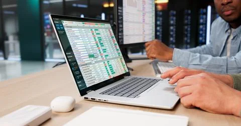 Young African American Coder Uses Laptop For Accurate Medical Billing Reports Stockfoto's