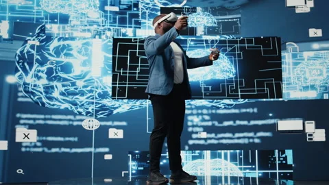 Young african american engineer focused on VR headset programming Stock Footage 312414331