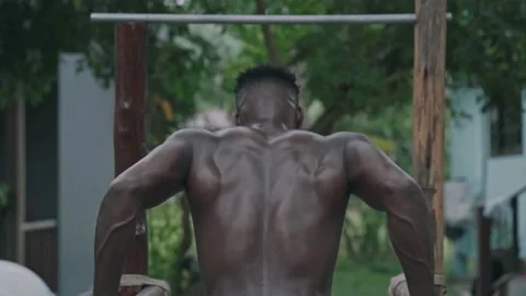 Young african american fit man doing dips on parallel bars Stock Footage