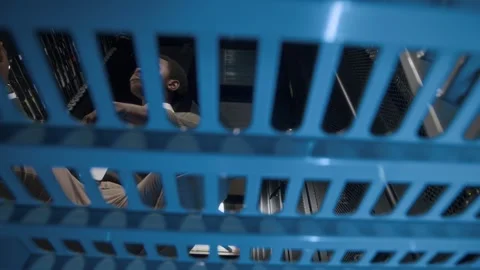 Young African American IT Engineer Examining Hardware in Server Room Stock Footage 303555992