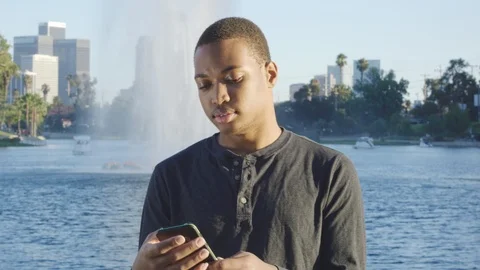 Young African american man using cellphone in Los Angeles Stock Footage 119336034