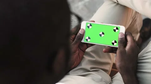 Young African American man using smartphone with mock up green screen.Close up Stock Footage 137973619
