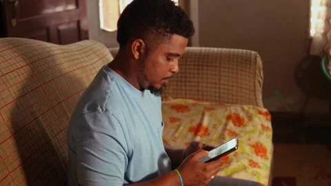 Young african american man using smartphone at home Video stock 328176285