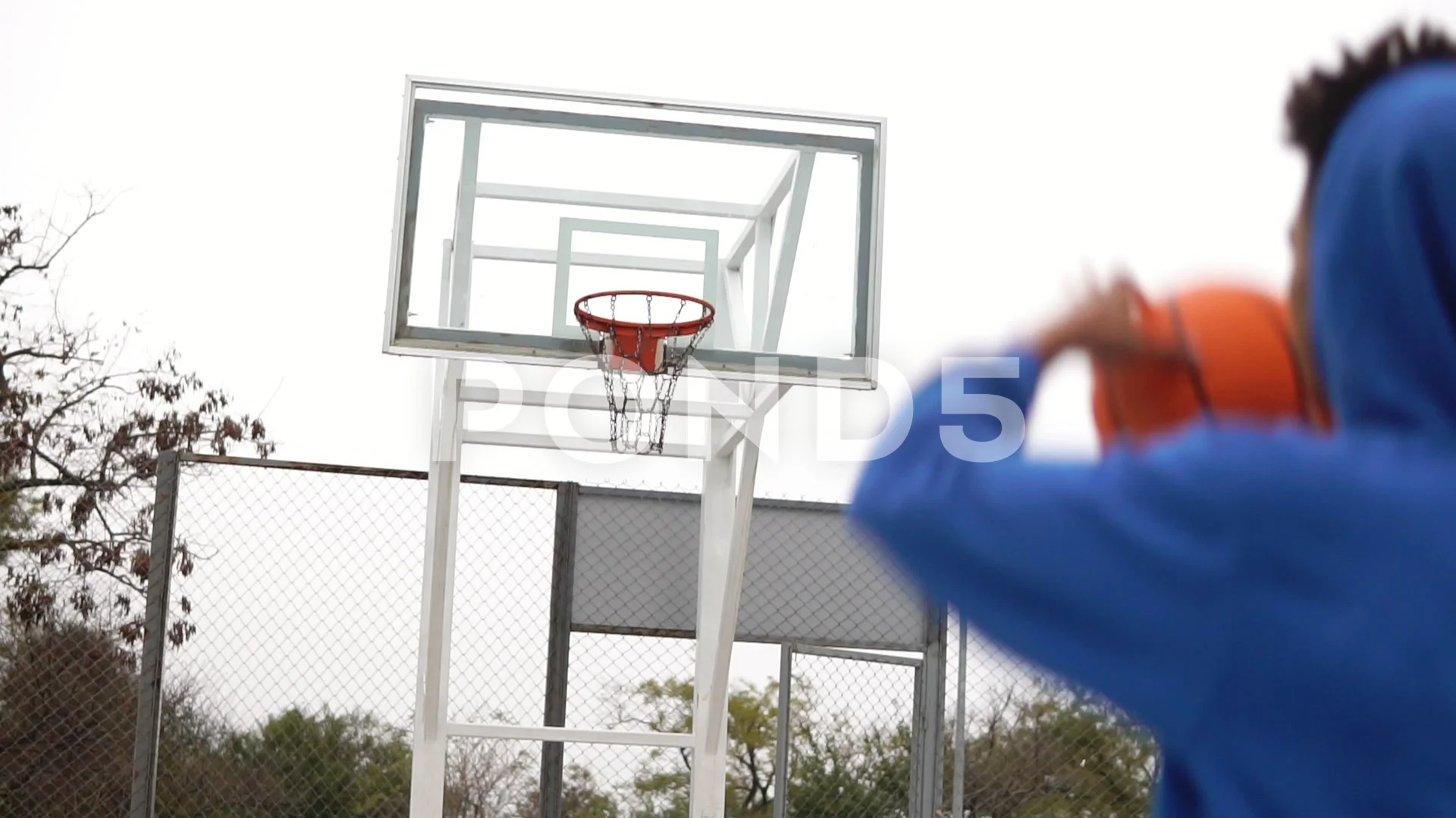 Handsome Young African American Throwing a Vintage Basketball