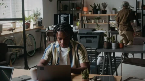 Young African American Programmer Working on Laptop in Comfortable Office Stock Footage 306212998