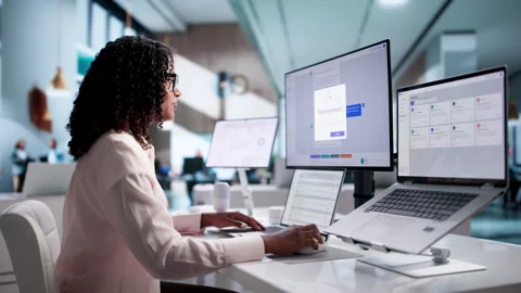 Young African American Software Engineer Using Desktop And Laptop Stock Footage 340405525